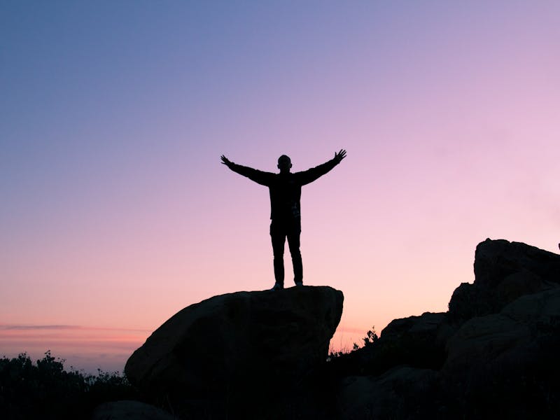Person on mountaintop above clouds